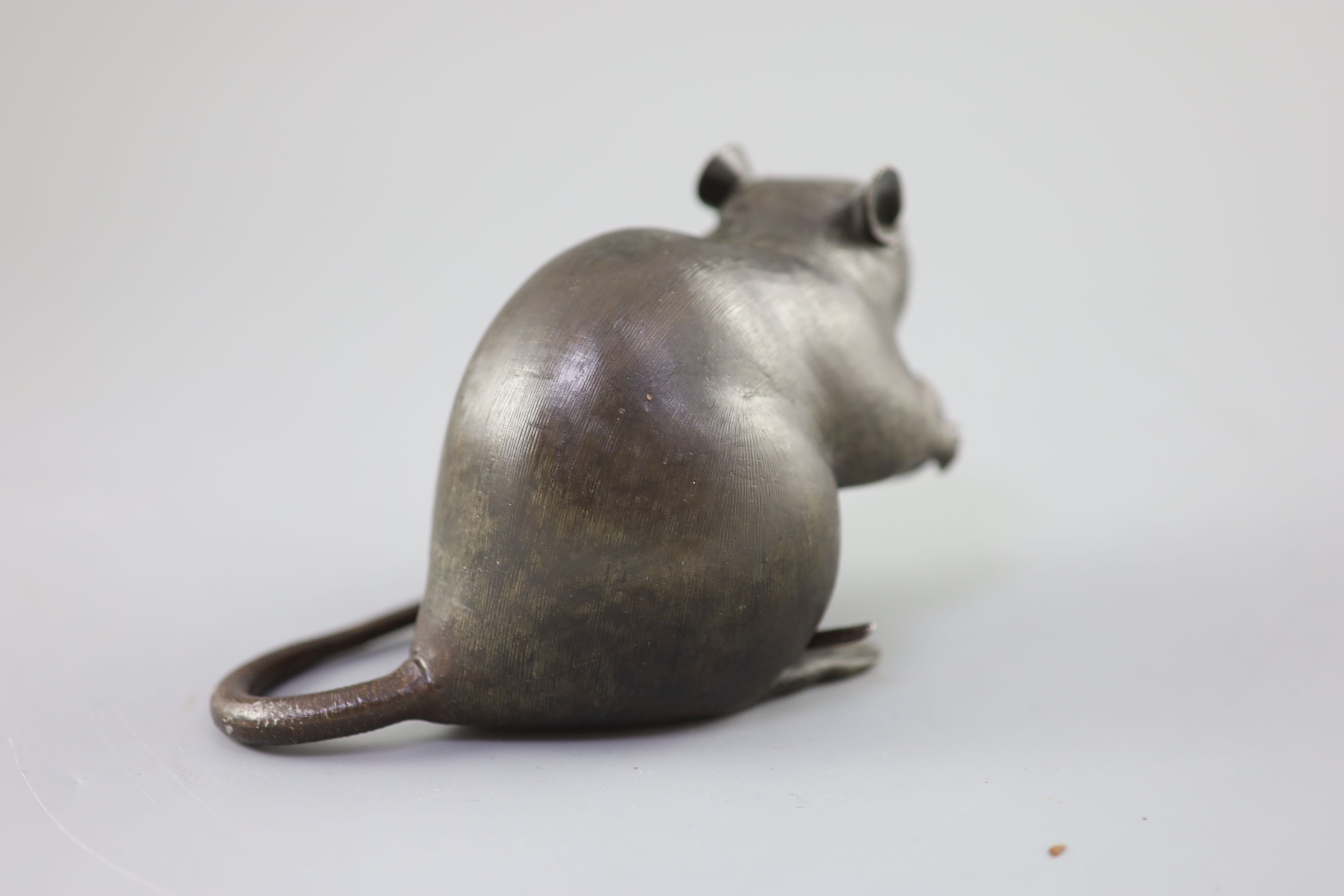 A Japanese bronze model of a rat holding a chestnut, Meiji period, 17cm long